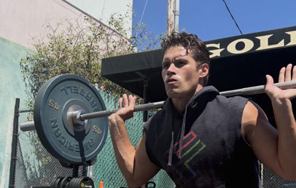 Coach Connor back squatting outdoors