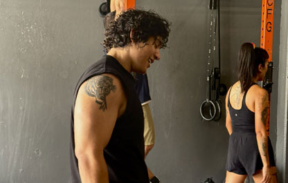 Coach Fernando sharing a laugh with members at the gym