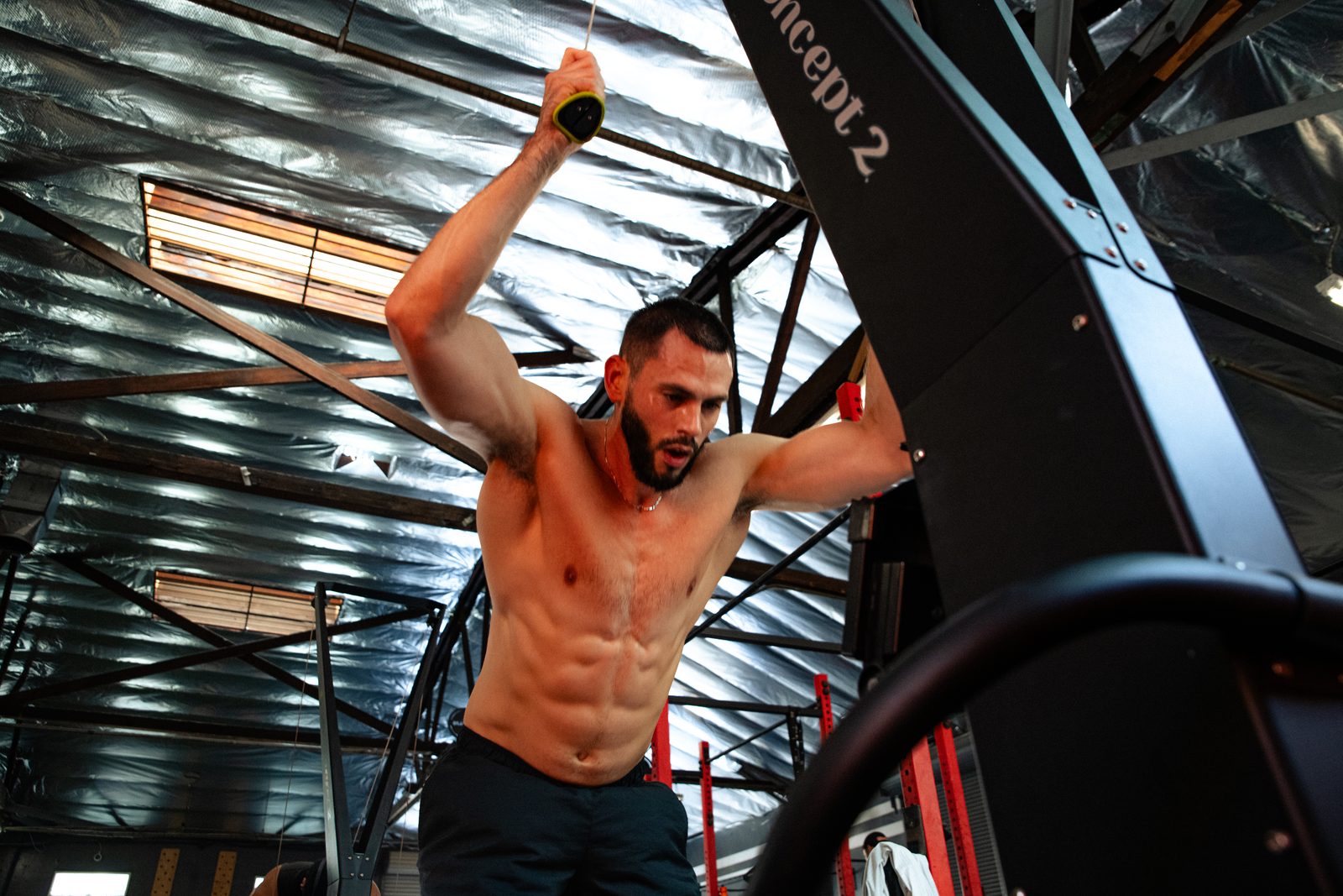 An athlete pulling on the SkiErg during HYROX training at Ganbatte Fitness